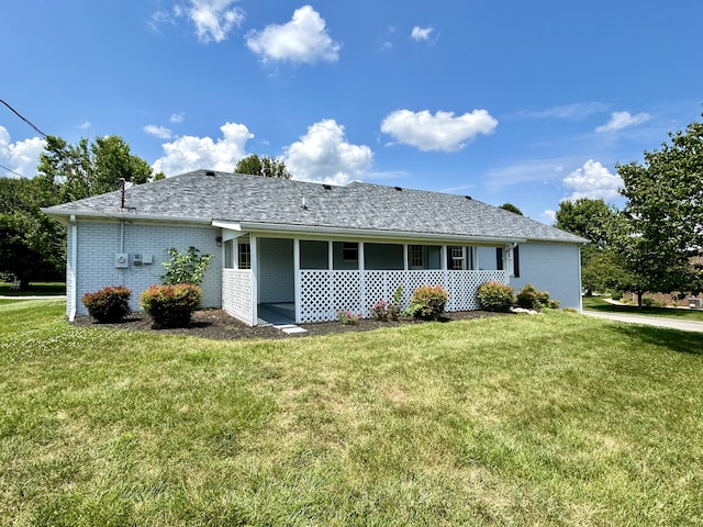 back of property featuring a lawn