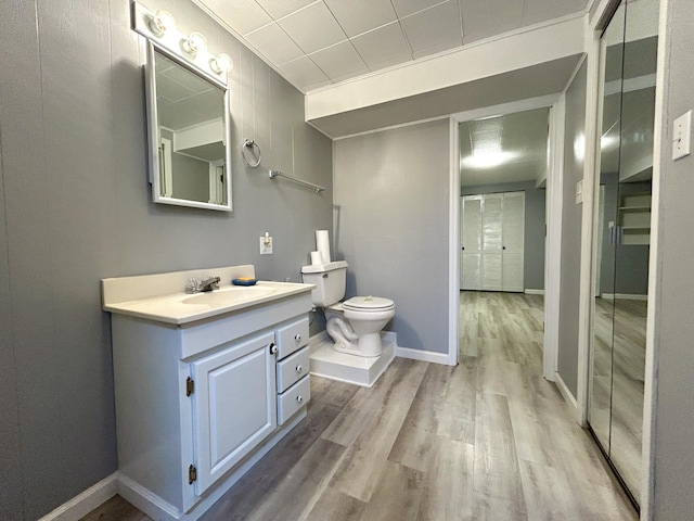 bathroom featuring hardwood / wood-style flooring, vanity, and toilet