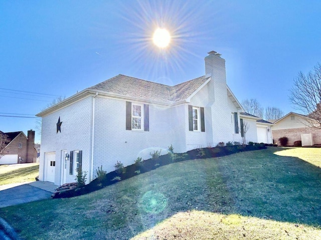 view of side of property featuring a garage and a yard