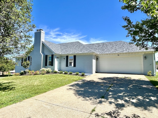 ranch-style home with a garage and a front yard