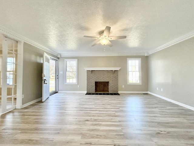 unfurnished living room with crown molding, a healthy amount of sunlight, and light hardwood / wood-style flooring