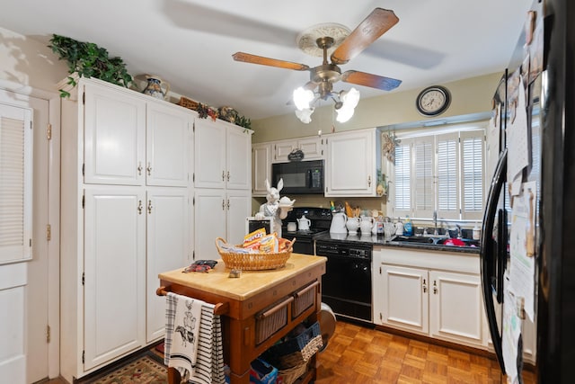 kitchen with white cabinetry, sink, light parquet flooring, and black appliances