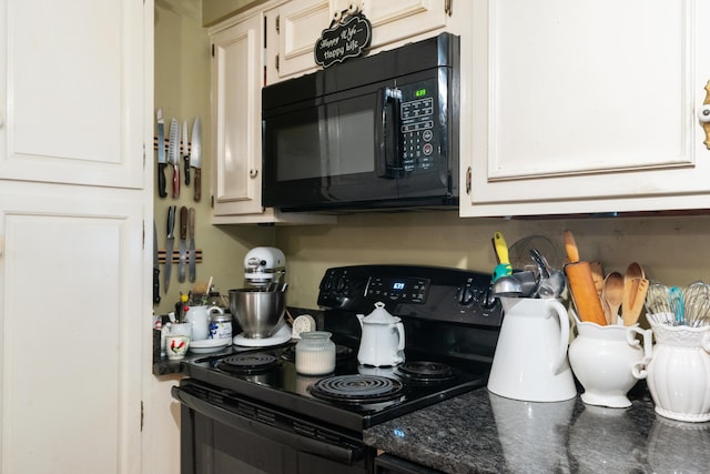 kitchen featuring white cabinets, dark stone countertops, and black appliances