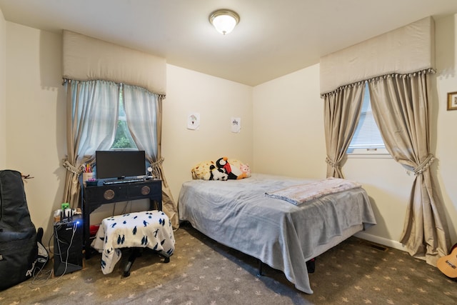 bedroom featuring dark colored carpet