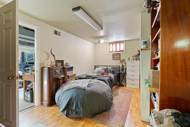 bedroom with hardwood / wood-style flooring