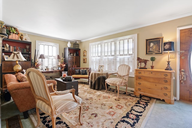 living area with carpet flooring and ornamental molding