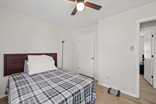 bedroom with ceiling fan and light wood-type flooring