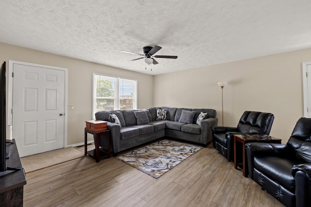 living room featuring a textured ceiling, ceiling fan, and hardwood / wood-style floors