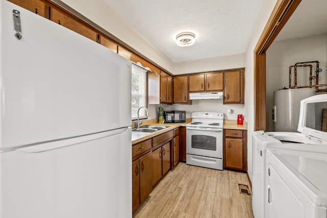 kitchen featuring light hardwood / wood-style floors, white appliances, independent washer and dryer, sink, and electric water heater