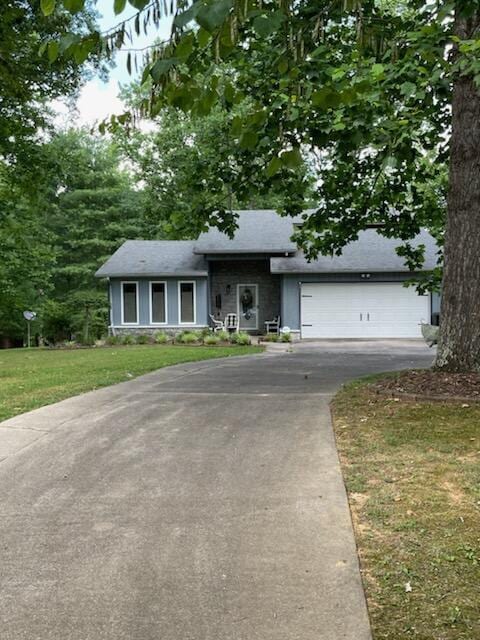 view of front facade with a garage and a front lawn