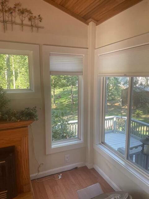 unfurnished sunroom featuring vaulted ceiling and wooden ceiling