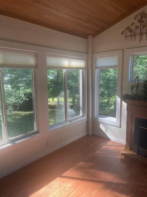 unfurnished sunroom with lofted ceiling and wood ceiling