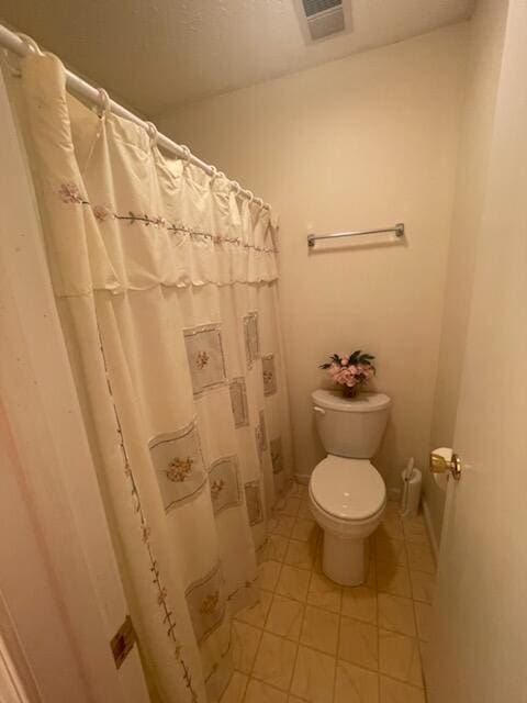 bathroom featuring tile patterned flooring and toilet