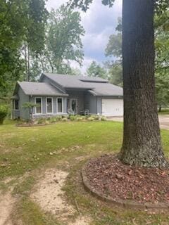 view of front of house with a front yard and a garage