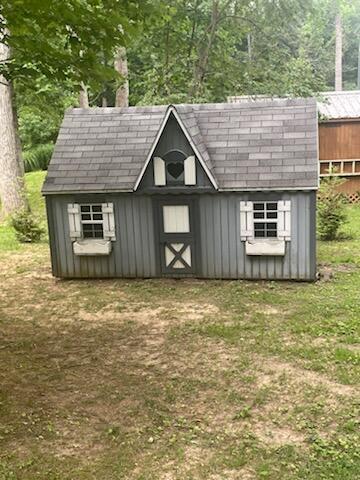 view of outdoor structure featuring a lawn