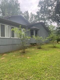 view of side of property featuring a yard