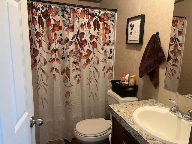 bathroom featuring vanity and toilet