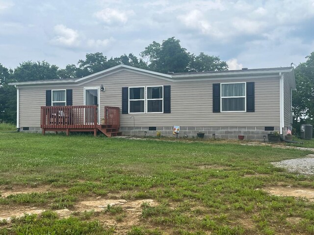 back of house featuring a yard and a deck