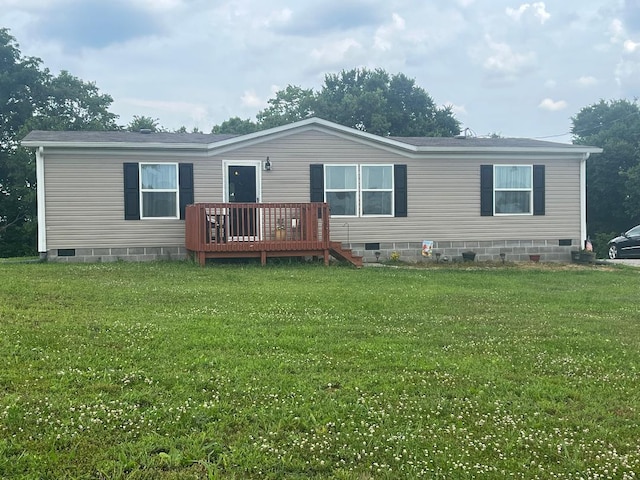 view of front of home with a deck and a front lawn