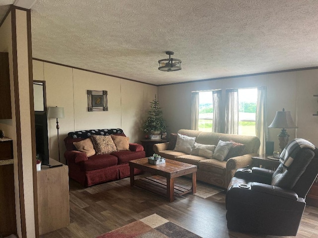 living room featuring ornamental molding, dark hardwood / wood-style floors, and a textured ceiling