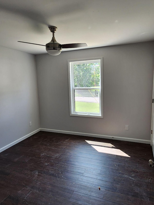 empty room featuring ceiling fan and dark hardwood / wood-style flooring