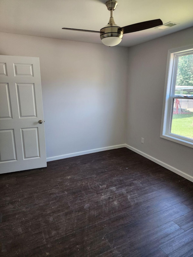 spare room with ceiling fan and dark hardwood / wood-style floors