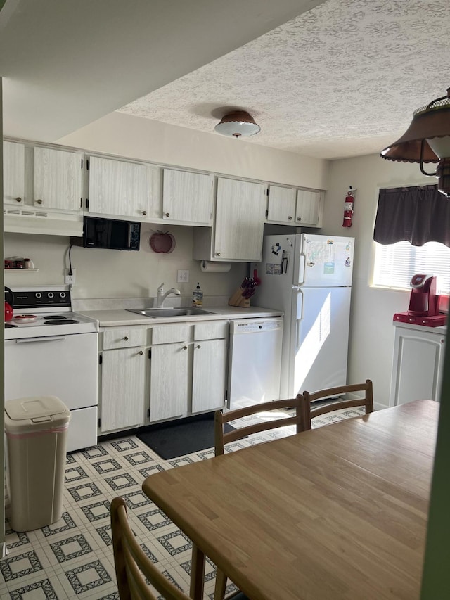 kitchen with white appliances and sink