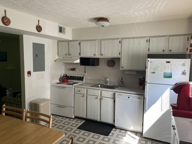 kitchen featuring a textured ceiling, white appliances, electric panel, and sink