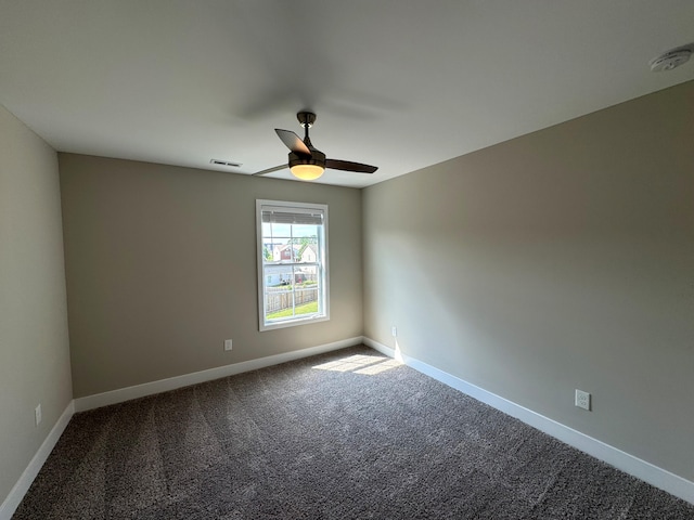 carpeted empty room featuring ceiling fan