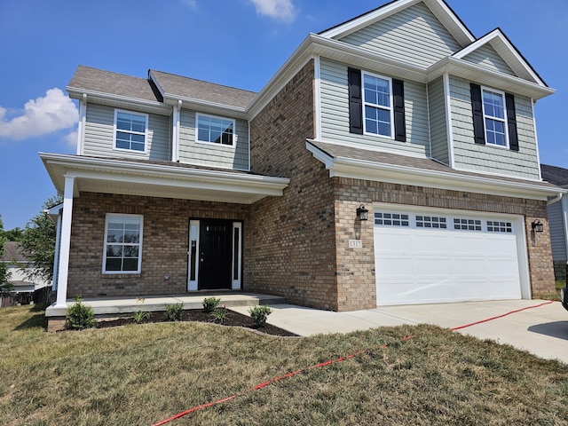 view of front of home featuring a front yard and a garage