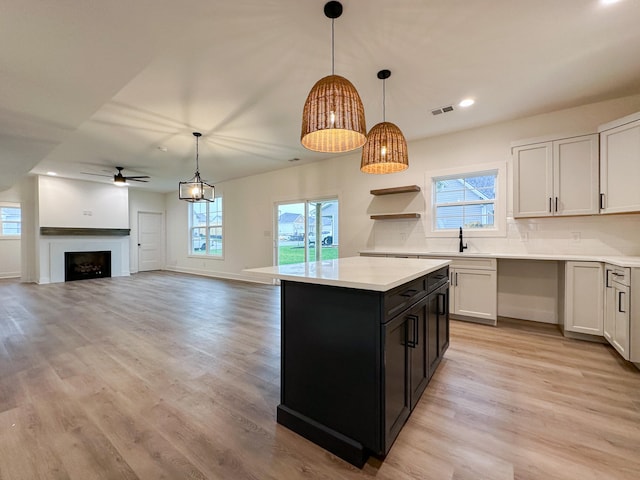 kitchen with plenty of natural light, pendant lighting, and white cabinetry