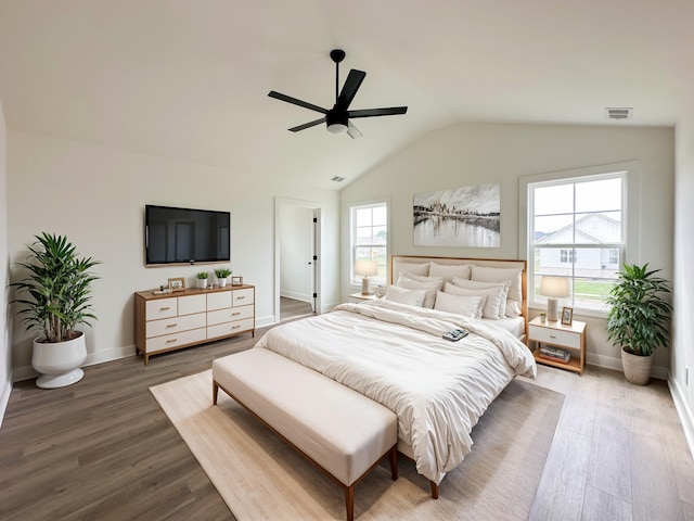 bedroom with hardwood / wood-style flooring, ceiling fan, and lofted ceiling