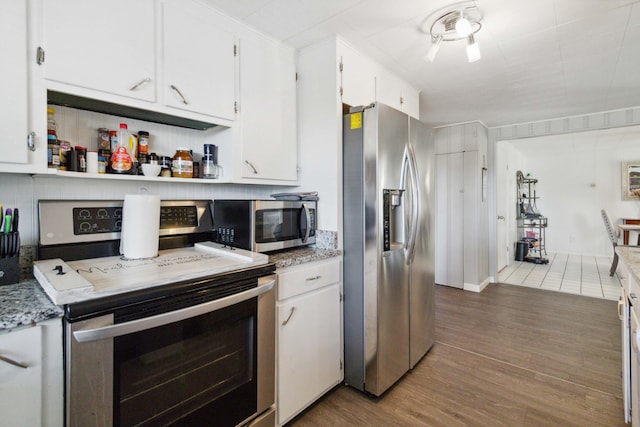 kitchen with white cabinetry, sink, dishwasher, and light stone countertops