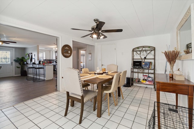 tiled dining area with ceiling fan