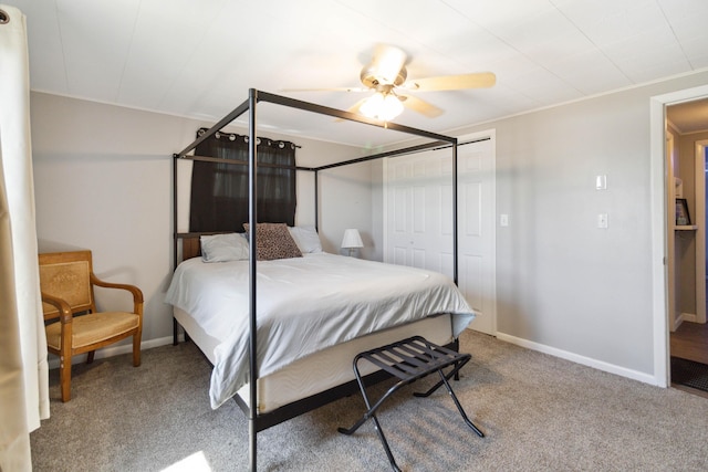 bedroom with ceiling fan, light colored carpet, and a closet