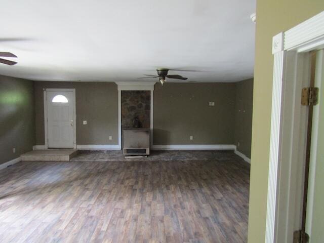 unfurnished living room with dark hardwood / wood-style floors and ceiling fan