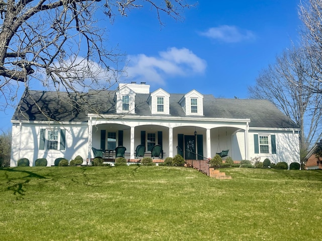 cape cod-style house featuring covered porch and a front yard