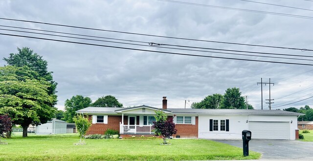 view of front facade with a garage and a front lawn