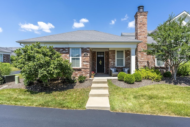 view of front of home featuring a front lawn and a porch