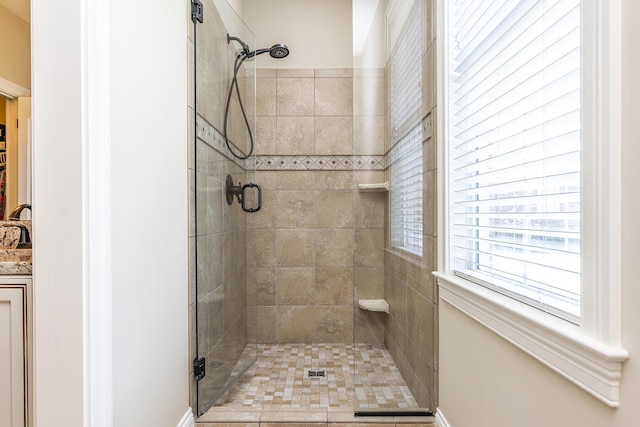 bathroom with a shower with door