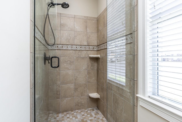 bathroom with a healthy amount of sunlight and walk in shower