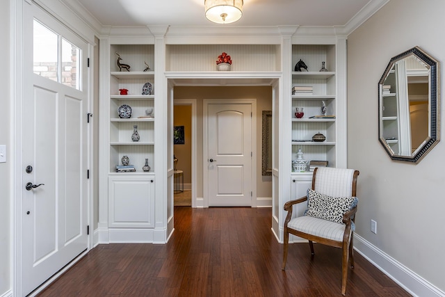 sitting room with dark hardwood / wood-style floors, built in features, and crown molding