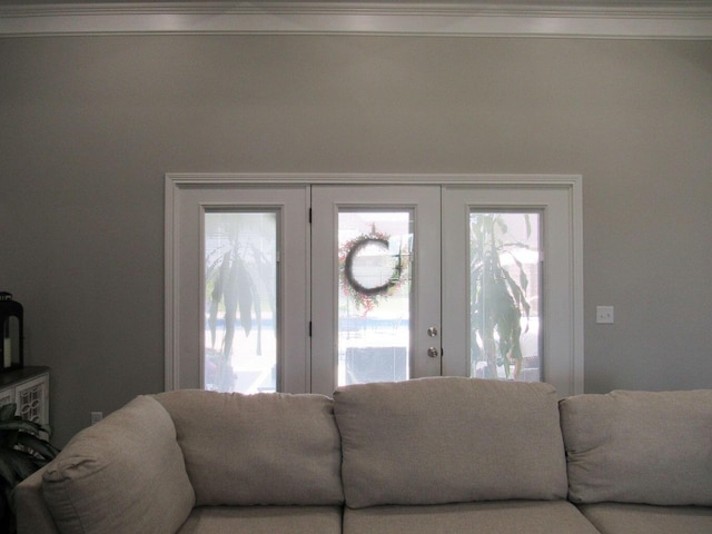 living area with plenty of natural light and ornamental molding