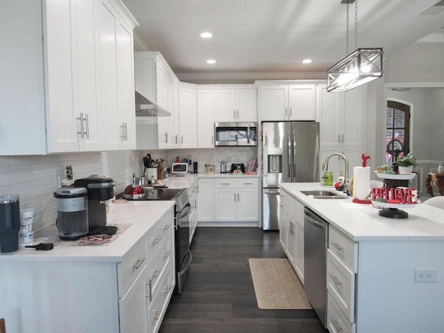 kitchen with tasteful backsplash, dark wood-style flooring, a sink, white cabinets, and appliances with stainless steel finishes