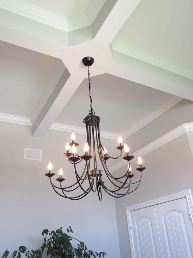 details featuring an inviting chandelier, ornamental molding, and visible vents