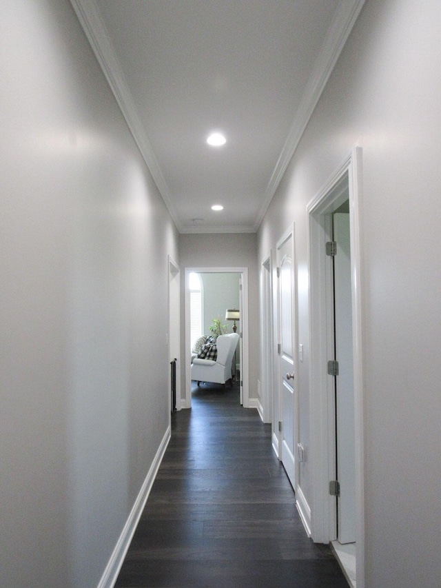 hallway featuring baseboards, dark wood-style flooring, recessed lighting, and crown molding