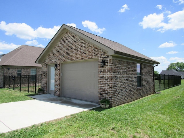 view of side of property with a yard, driveway, brick siding, and fence