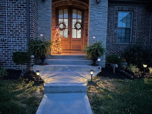 doorway to property with brick siding and french doors