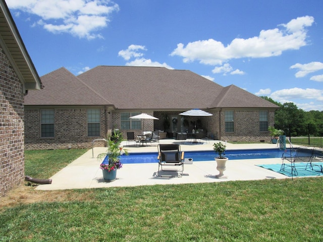 view of pool with a yard, a patio, a fenced in pool, and fence