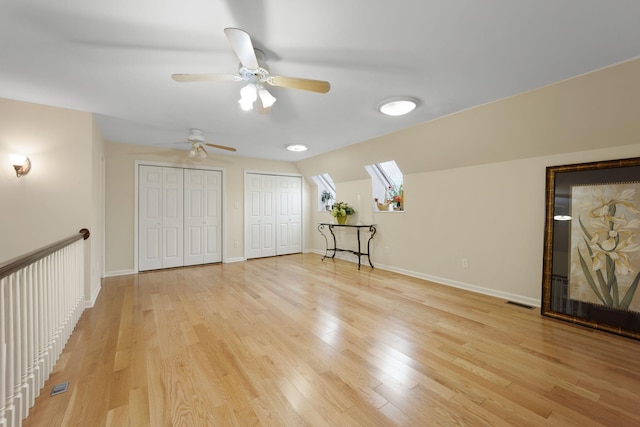 interior space featuring light wood-type flooring, vaulted ceiling, and ceiling fan